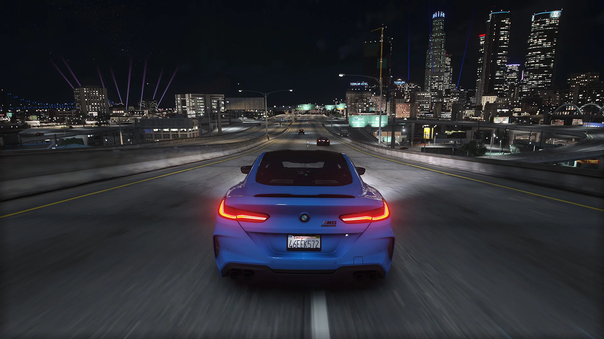 Blue coupe cruising along a Los Santos freeway at night